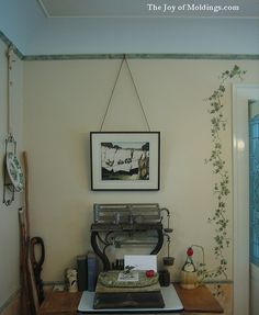 an old fashioned record player sitting on top of a wooden table in front of a painting