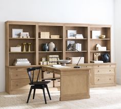 a desk and chair in front of an open bookcase