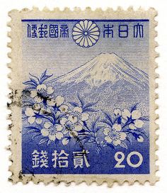 a stamp with flowers and mountains on it