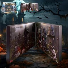 an open book with pictures on it in front of a spooky house at night