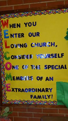 a bulletin board on the side of a brick wall with an image of a tree