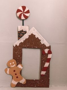 a gingerbread house with a candy cane on top