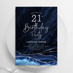 a blue marble birthday party card on a plate