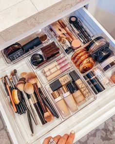 the drawers are filled with makeup and brushes