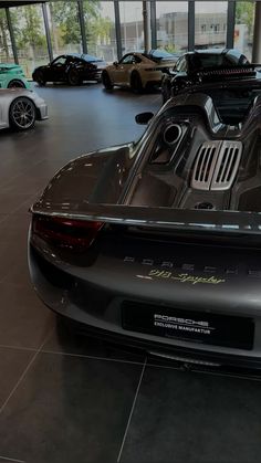 the back end of a sports car in a showroom