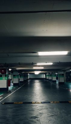 an empty parking garage with no one inside or outside the space on the floor,