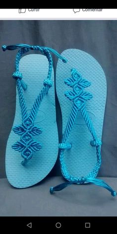 a pair of blue sandals sitting on top of a table