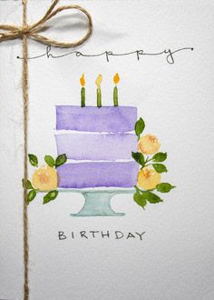 a birthday card with a purple cake and yellow flowers on it, tied to a piece of paper