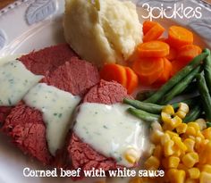 corned beef with white sauce and vegetables on a plate