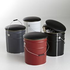 three black, white and red buckets sitting next to each other