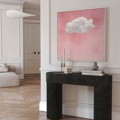 a painting on the wall above a console table