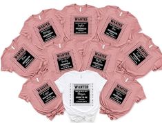 a group of pink shirts with black words on them, all in the shape of a circle