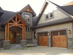 a large house with two garages and three windows