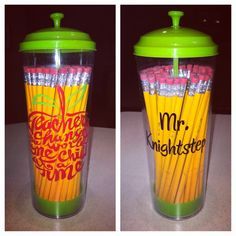 two cups with pencils in them sitting on a counter top next to each other