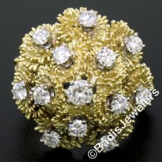 You are looking at a uniquely designed vintage ring crafted in solid 18k yellow gold, and features large, tiered design consisting of amazingly textured reef-like settings that cluster gorgeously across its top. The ring is accented with 12 stunning diamonds that sit at the center of each reef design, and then at the very top center sits a fine diamond that weighs approximately 0.22 carats. The fiery shine and sparkle that come out of the diamonds on this ring reflect their top quality as they a Luxury Yellow Gold Cluster Ring, Montclair Nj, Ring Crafts, Vintage Ring, Diamond Cluster, Emerald Diamond, Cocktail Ring, Eternity Bands, Brilliant Cut Diamond