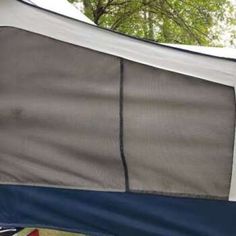 the inside of a tent with trees in the back ground and blue tarp over it