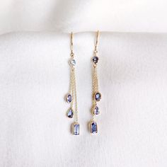 These stunning earrings are set in 14k Solid Yellow Gold with Natural Tanzanite with utmost precision. It is an unique and dainty gemstone earring pair for nearly every occasion and is completely hassle-free jewelry. ITEM DETAILS: * Gem: Tanzanite * Gem Size: 2.5mm (2pcs) * Gem Shape: Round Cut * Gem Size: 2.5X3mm (2pcs) * Gem Shape: Oval Cut  * Gem Size: 3X4mm (2pcs) * Gem Shape: Pear Cut  * Gem Size: 3X5mm (2pcs) * Gem Shape: Baguette   * Gem Weight: 1.56 carats * Gold Purity: 14KT ~ also avai Elegant Tanzanite Dangle Earrings, Elegant Multi-stone 14k Gold Earrings, Yellow Gold Tanzanite Jewelry With Matching Earrings, Elegant Gold Tanzanite Earrings, Handmade Jewelry Box, Tanzanite Earrings, Birthstone Earrings, Earrings Christmas, Earrings Dainty