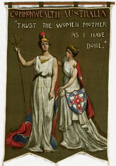 two women in white dresses holding flags and standing next to each other with words written on them