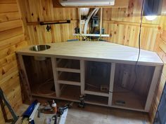 a kitchen under construction with wood paneling on the walls