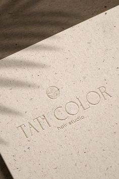 the logo for tattoo color is shown on top of a white paper with brown speckles