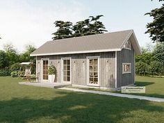 a small wooden house sitting on top of a lush green field