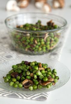 peas and mushrooms in a glass bowl on a table