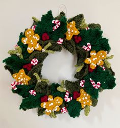 a crocheted christmas wreath hanging on the wall