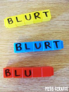 the word blurt spelled with blocks on top of a wooden table next to each other