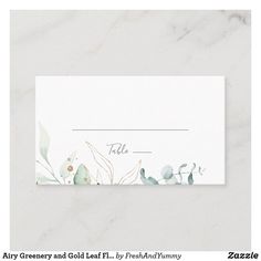 a place card with watercolor flowers and leaves on white marble background for wedding or baby shower