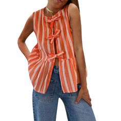 a woman standing with her hands on her hips wearing an orange and white striped top