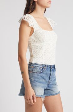 Turn on the romance in this top with a layer of pretty eyelet defining the fitted silhouette and forming the barely there cap sleeves. 17" length (size Medium) Button half placket Square neck Cap sleeves Partially lined 100% cotton Hand wash, dry flat Imported