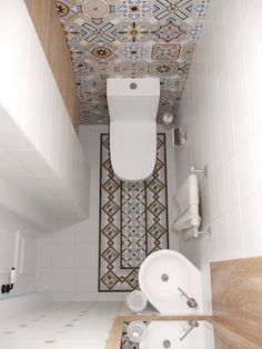 a bathroom with a toilet, sink and bathtub next to a tiled wallpapered ceiling