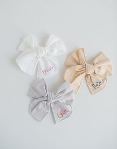 We love these custom hand-embroidered name hair bows! Bows are fable style and available in seven different colors with each name hand-embroidered onto the right side of the bow. These make perfect gifts for the little loves in your life! ---- DETAILS: - This listing is for one name bow with an alligator clip. Each item is made-to-order. - Names are hand-embroidered on each bow, seven letter max. - Bows are approximately 3.5 inches HOW TO ORDER: 1 - Pick bow & thread colors 2 - Name (case sensit Cute White Cotton Hair Accessories, White Cotton Hair Accessories For Gifts, White Cotton Hair Accessories For Gift, White Cotton Hair Accessories As Gift, Cute Cotton Bow Hair Accessories, Cute Cotton Hair Accessories For Gifts, Cotton Bow Hair Accessories For Gifts, Cotton Bow Hair Accessories For Gift, Embroidery Bow