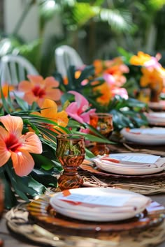 the table is set with flowers and plates