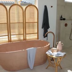 a large bath tub sitting next to a window