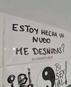 a sign that is on the side of a wall with writing in spanish and english