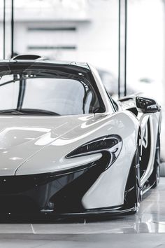 a white and black sports car in a showroom