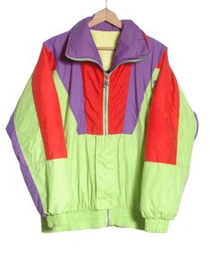 Vintage C&A Rodeo ski jacket from the 1980's. Retro look in a neon green, purple and red colour. Zip front concealed and three front pockets. Elasticated waist and cuffs. Made in Italy from a nylon fabric with padded inside lining.  Condition: Excellent vintage condition. Chest: 46in Length: 28in Inside sleeve: 20in More vintage clothing on our website www,brickvintage.com Retro Long Sleeve Track Jacket For Winter, Retro Nylon Track Jacket For Outdoor, Retro Long Sleeve Track Jacket For Outdoor, Retro Outdoor Track Jacket With Long Sleeves, Retro Long Sleeve Windbreaker For Winter, Retro Nylon Outerwear For Outdoor Activities, Vintage Patchwork Windbreaker For Outdoor, Retro Spring Track Jacket For Outdoor, Vintage Fitted Track Jacket For Winter