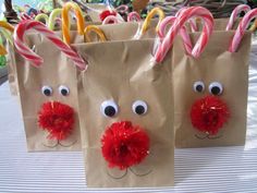 three brown paper bags decorated with candy canes and reindeer noses