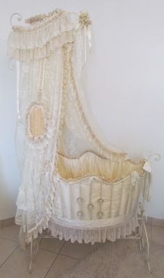 an old fashioned crib with a canopy over it's head and foot rests on a tile floor