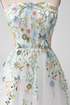 a white dress with colorful flowers on it