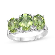 Whether it celebrates an August birthday or just a favorite color, this spring-green peridot ring will be an everyday favorite. Fashioned in sterling silver The center 9mm x 7mm oval-cut peridot is flanked by two slightly smaller ones in this fun three-stone design Gold Layered Bracelets, Pearl Diamond Jewelry, Cross Jewelry Necklace, Fan Jewelry, 3 Stone Ring, Jewelry Online Store, 3 Stone Rings, Three Stone Ring, Peridot Ring