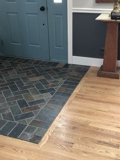 a blue front door and wooden floor in a house