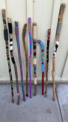 there are many different colored canes lined up on the wall