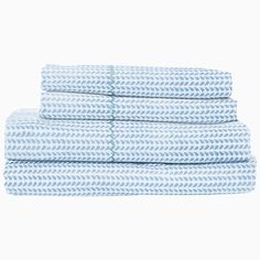 four blue and white towels stacked on top of each other