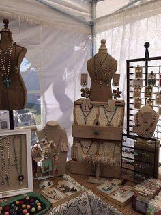 a table topped with lots of different types of necklaces and bracelets on display