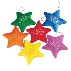 four star shaped ornaments with the words start on them in different colors and sizes, hanging from strings