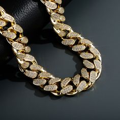 Looking for a little extra something to take your outfit from drab to fab? Check out our 18mm Heavy Luxury Cuban Link Necklace! This sizzling piece is crafted from high quality 14k gold plated metal and adorned with dazzling cubic zirconia stones. It's the perfect way to add a touch of luxury to any outfit.And the best part? Our Cuban link necklace is available in a variety of lengths from 14 inch to 30 inch, so you can choose the perfect fit for your style. Whether you're looking for a subtle a 14k Yellow Gold Iced Out Necklace, Elegant 14k Gold Iced Out Necklace, Elegant Iced Out 14k Gold Necklace, Gold Iced Out Round Necklace, Iced Out Round Gold Necklace, Luxury Iced Out Yellow Gold Necklace, Gold Cuban Link Diamond Jewelry, Yellow Gold Cuban Link Necklace With Cubic Zirconia, Gold Plated Curb Chain Jewelry