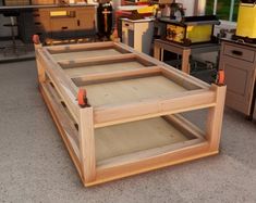 a wooden shelf sitting in the middle of a room filled with cabinets and other items