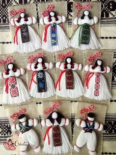 twelve handmade christmas ornaments are arranged on a tablecloth with red and white ribbons